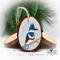 A three inch diameter wood slice with a hand-painted bird at Cove Creek Photography.